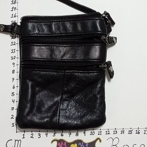 Unbranded travel purse. Feels like leather but no material label